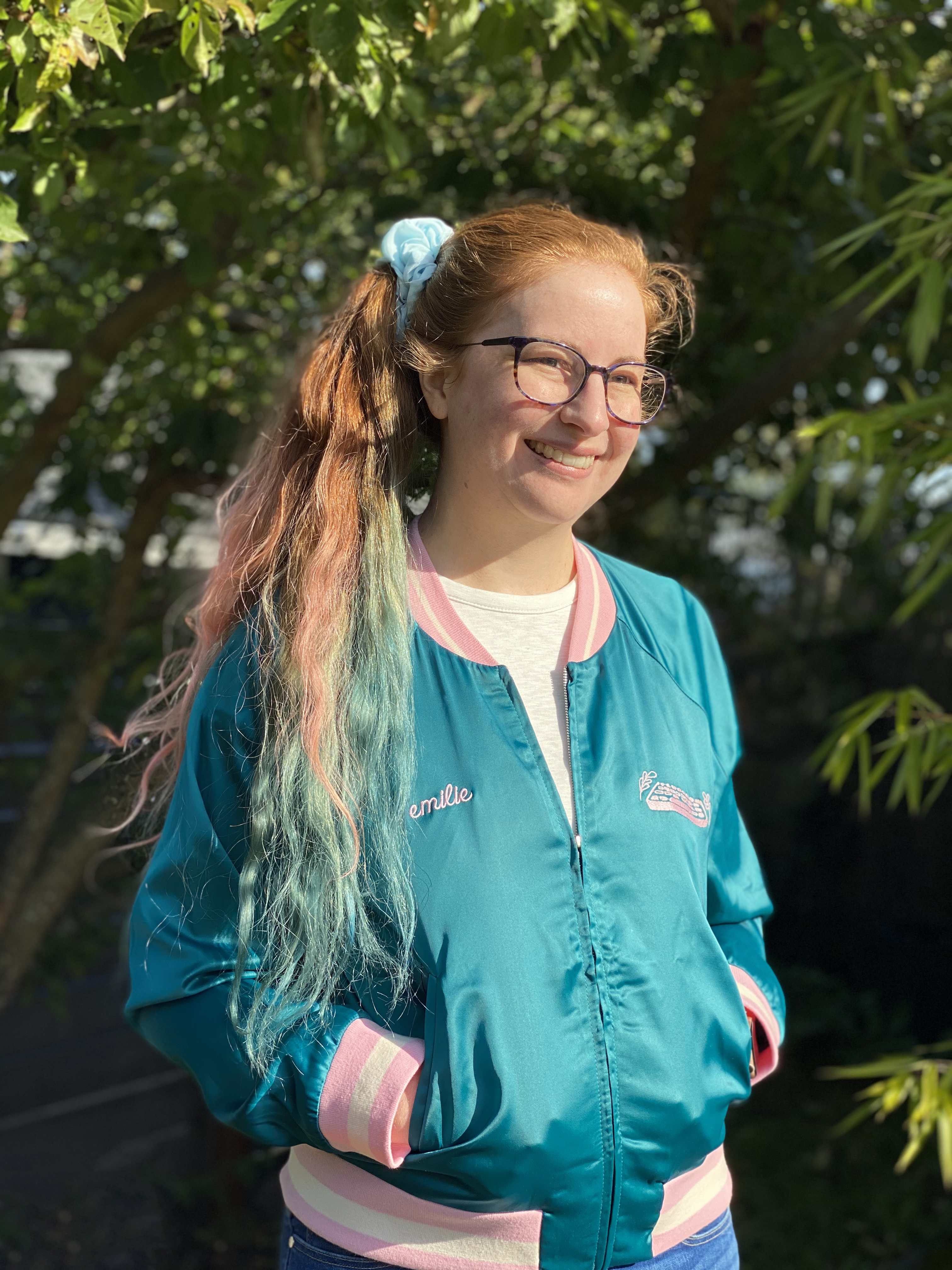 Portrait photo of Emilie standing outside.